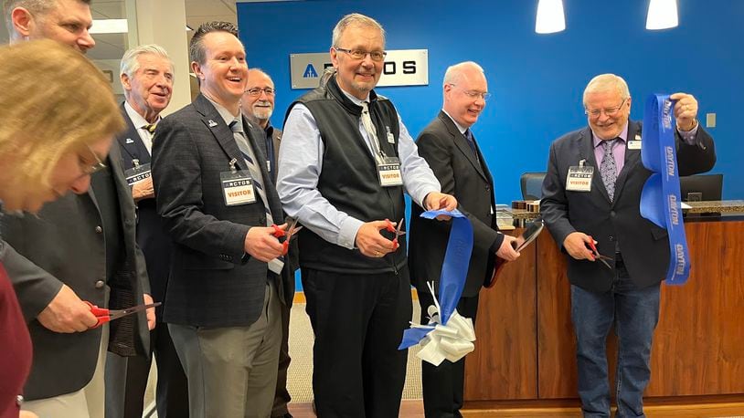 A ribbon was cut Tuesday on new Mission Point offices for Beavercreek defense contractor ARCTOS Technology Solutions. From the right are Beavercreek Mayor Bob Stone and Chris Greamo, the company's president and chief executive. THOMAS GNAU/STAFF