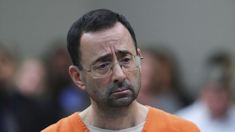 In this Nov. 22, 2017, file photo, Dr. Larry Nassar, 54, appears in court for a plea hearing in Lansing, Mich. Nassar was sentenced to decades in prison for sexually assaulting young athletes for years under the guise of medical treatment. (AP Photo/Paul Sancya, File)