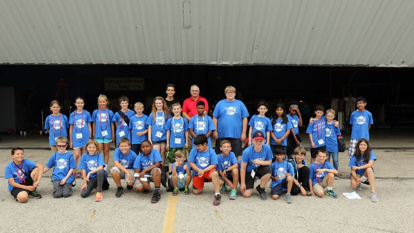 Frank Beafore (center in the red shirt). executive director of the SelectTech GeoSpatial presence at Springfield-Beckley Municipal Airport, with a few of his friends -- a group of Air Camp students. Contributed