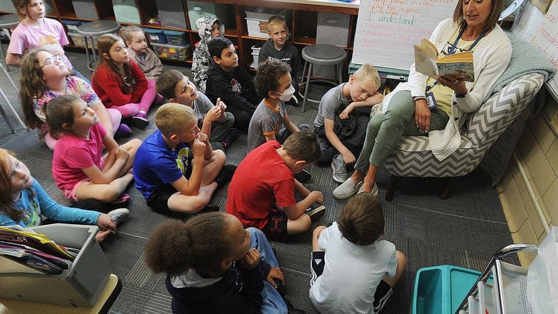 First-grade teacher Angie Beal reads to her class at Oakview Elementary in Kettering. MARSHALL GORBY\STAFF