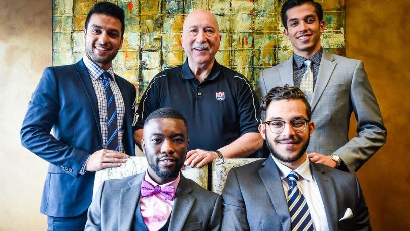 Greg Ossmann (back row, middle), the executive director of the National Football League’s Players Association in Cincinnati, mentors four men from Butler County as they grow into their professional careers. The four are all founders of Civility International, which teaches civility to local youth and rewards civil acts.