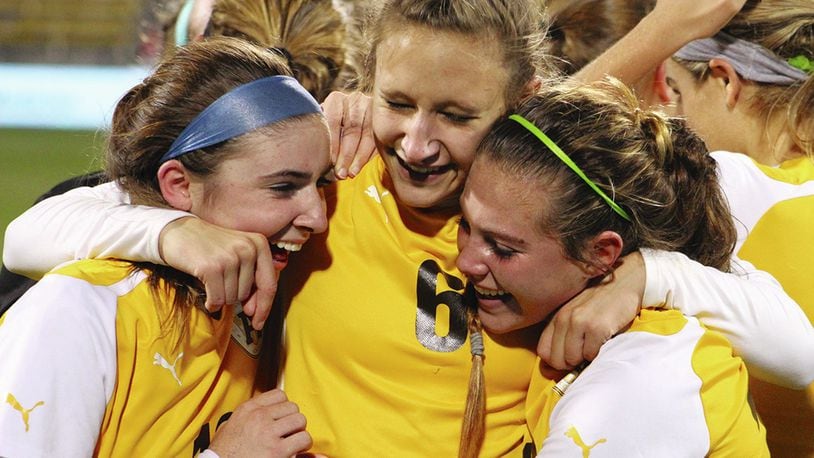 From left, Alter’s Grace Haines, Ashley Maples and Lauren Dietz celebrate the school’s first girls soccer state title. The Knights beat Chagrin Falls 3-0 in the Division II final Saturday night at MAPFRE Stadium in Columbus. Jeff Gilbert / Contributed photo
