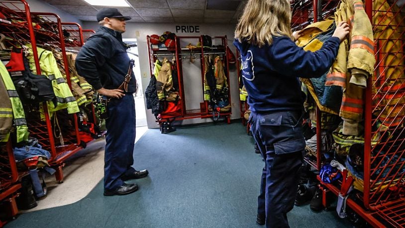 Miami Valley Fire District Battalion Chief Mike Renk (left) and firefighter/EMT Emma Brown examine old turnout gear at Station 52, 2710 Lyons Road, Miami Twp., Friday, Nov. 11, 2022. JIM NOELKER/FILE