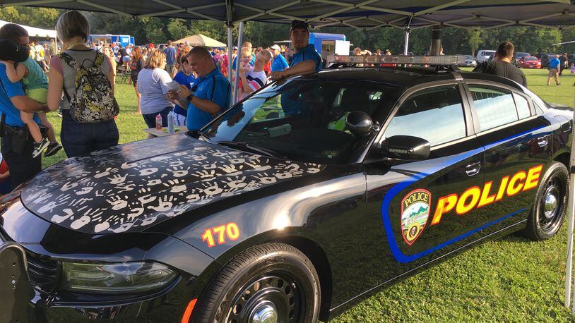Last year, children added their handprints onto a Franklin police cruiser during the city’s first National Night Out. This year’s event starts at 5:30 p.m. today, Aug. 7, at Community Park. ED RICHTER/STAFF