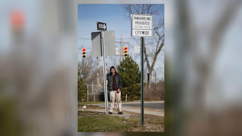 Despite the city's new sign outlawing panhandling, Tom Holbrook, 57, stands at the exit ramp from 315 to Long Street in Columbus waiting for drivers to give him enough money for a cigar and beer on Wednesday, Jan. 6, 2016. (Adam Cairns / The Columbus Dispatch)