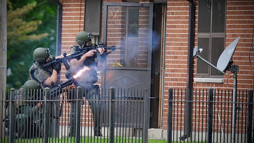 The Dayton SWAT team fires tear gas into an apartment May 18, 2022, after a man shot another man and then went back inside an apartment in the 1700 block of West Stewart Street. The victim, identified Tuesday, May 24, as 29-year-old Myquan R. Taylor, later died of his injuries. MARSHALL GORBY\STAFF