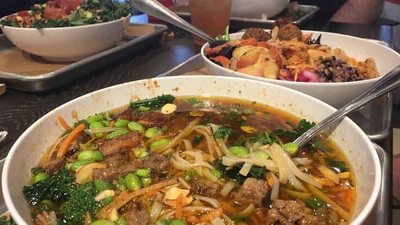 CoreLife Eatery has everything you need to meet your New Year’s resolution goals. The spicy ginger steak and rice noodles broth bowl with some added edamame with a spicy chicken bowl and a poke tuna salad bowl in the background. CONTRIBUTED PHOTO BY ALEXIS LARSEN