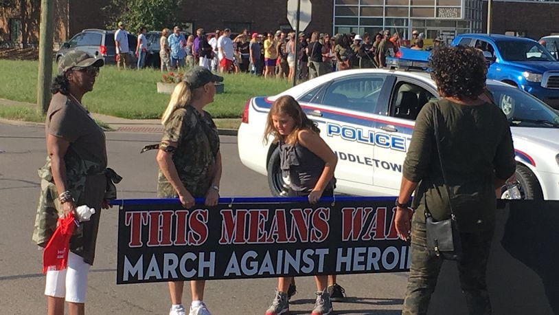 About 75 people, many wearing fatigues, marched down Yankee Road in Midddletown on Saturday as part of “500 Women Against Heroin.”