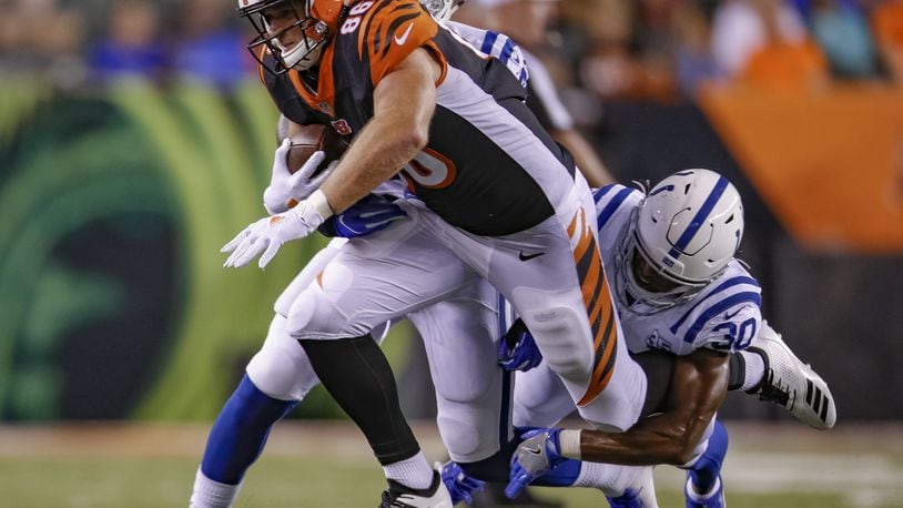 CINCINNATI, OH - AUGUST 30: Mason Schreck #86 of the Cincinnati Bengals runs the ball and is tackled from behind by George Odum #30 of the Indianapolis Colts during a preseason game at Paul Brown Stadium on August 30, 2018 in Cincinnati, Ohio. (Photo by Michael Hickey/Getty Images)