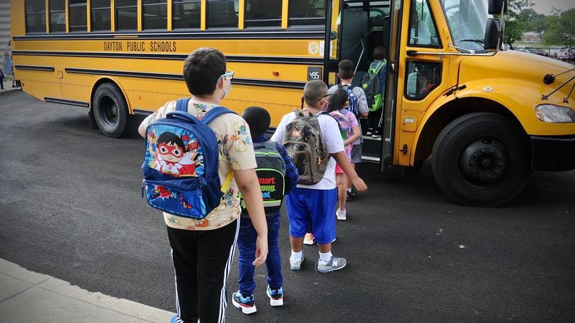 Students at Eastmont elementary in Dayton wait to board the bus at the end of the first day of school on Wednesday Aug. 18, 2021. MARSHALL GORBY\STAFF