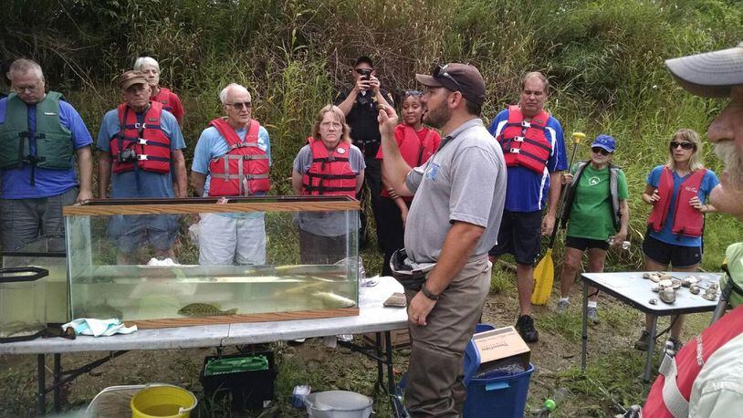 Donald Knight from the U.S. Fish and Wildlife Service talks with participants in a 2016 canoe trip along the Great Miami River about habitat and wildlife along the river corridor during a stop at the 38-acre Miami County Park District Duke Park extension property at Troy. The property is one of hundreds of acres owned by the park district. CONTRIBUTED