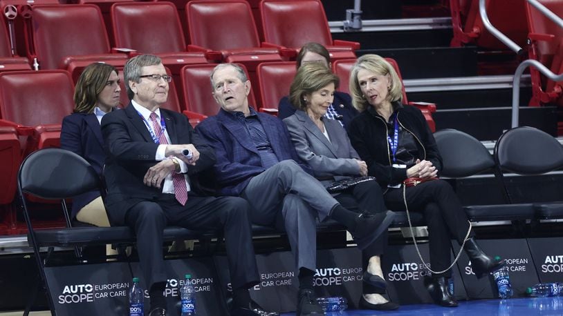 George W. Bush, second from left, and Laura Bush, second from right, sit courtside at Moody Coliseum on Wednesday, Nov. 29, 2023, before a game between Dayton and SMU in Dallas, Texas. David Jablonski/Staff