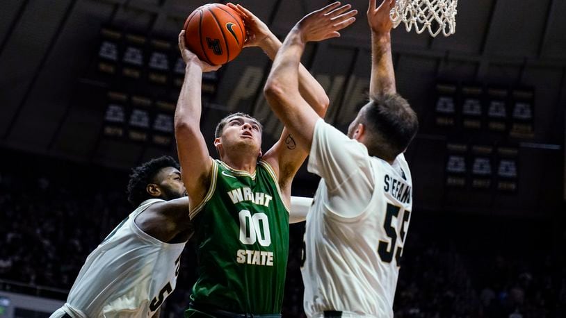 Wright State forward Grant Basile (00) shoots over Purdue guard Sasha Stefanovic (55) during the first half of an NCAA college basketball game in West Lafayette, Ind., Tuesday, Nov. 16, 2021. (AP Photo/Michael Conroy)