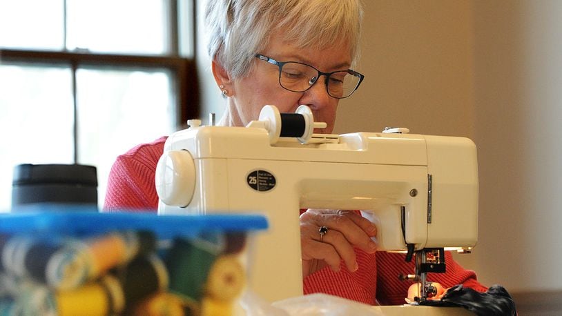 Ne-Dral Dalton is part of a group of ladies at the David's United Church of Christ in Kettering that make fleece scarves, hats and mittens to donate. MARSHALL GORBY\STAFF