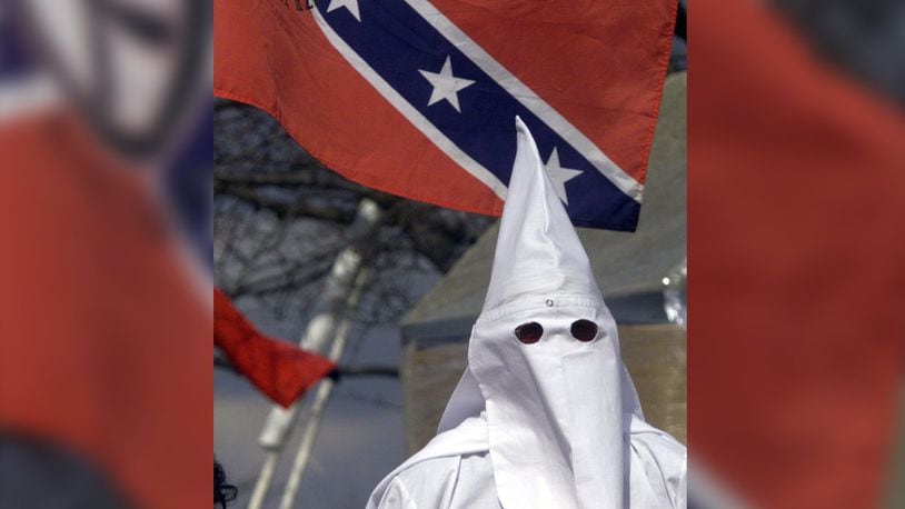 A Ku Klux Klan member stands on the stairs of the Kettering Government Center during a 2005 rally. FILE