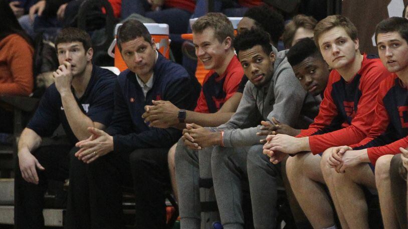 Dayton's Charles Cooke, fourth from right, watches from the bench during a game against St. Bonaventure on Jan. 3, 2017.