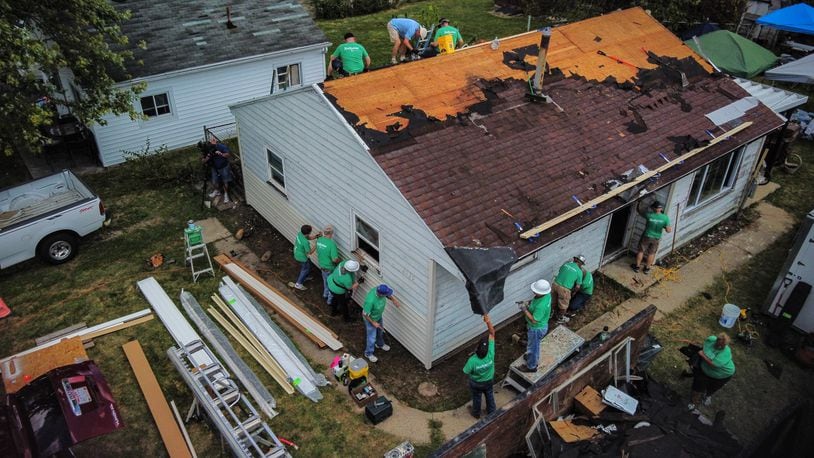 Volunteers from Shiloh Church and corporate partners reroof a house on Oneida Ave. in Harrison Twp. Thursday, Sept. 9, 2021. The house was damaged by the 2019 Memorial Day tornados. JIM NOELKER/STAFF