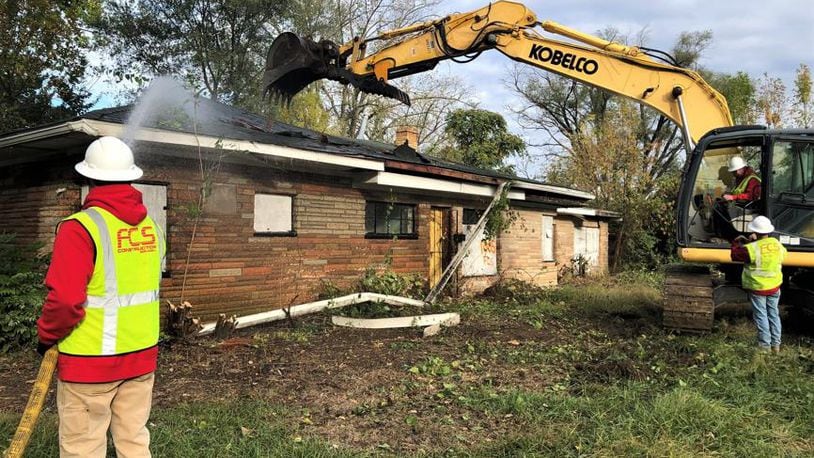 A crew with FCS Construction Services Inc. tears down a home on the 1000 block of Roseland Avenue in the Westwood neighborhood. CORNELIUS FROLIK / STAFF