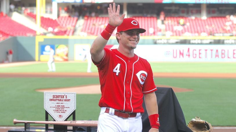 The Reds’ Scooter Gennett waves to the crowd during a pregame ceremony honoring him before a game against the Dodgers on Friday, June 16, 2017, at Great American Ball Park in Cincinnati. David Jablonski/Staff