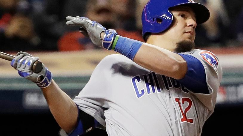 In this Tuesday, Oct. 25, 2016, photo, Chicago Cubs’ Kyle Schwarber, wearing a green wristband on his left arm, hits a double during the fourth inning of Game 1 of the Major League Baseball World Series against the Cleveland Indians in Cleveland. Some 1,700 miles away from Wrigley Field, no one is enjoying Schwarber’s comeback from a major knee injury more than Campbell Faulkner, a boy with a life-threatening illness, and his family. The 10-year-old Faulkner stays up to watch his buddy in the World Series, and Schwarber proudly wears his Campbell’s Crew wristband while he tries to help the Chicago Cubs to their first championship since 1908. (AP Photo/David J. Phillip)