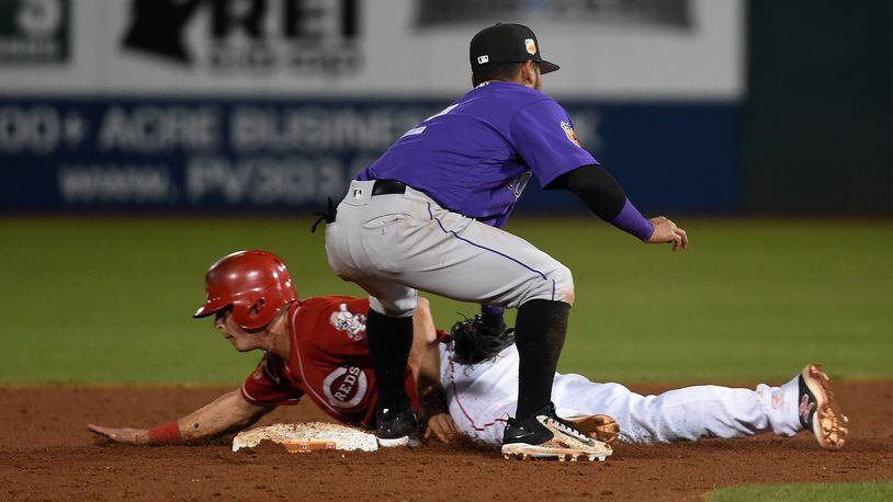 GOODYEAR, AZ - MARCH 10: Tony Renda #49 of the Cincinnati Reds is tagged out by Alexi Amarista #2 of the Colorado Rockies while attempting to steal second base during the second inning at Goodyear Ballpark on March 10, 2017 in Goodyear, Arizona. (Photo by Norm Hall/Getty Images)
