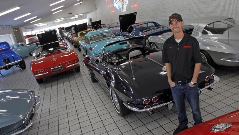 Shelby Mershon, surrounded by classic Corvettes, stands in the showroom of Mershon’s World of Cars in Springfield. © 2018 Photograph by Skip Peterson