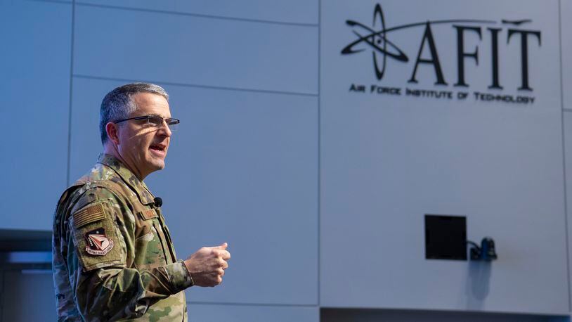 Maj. Gen. William Cooley, Air Force Research Laboratory commander, gives the keynote presentation at the Air Force Institute of Technology Centennial Symposium on Wright-Patterson Air Force Base Nov. 7. The event’s theme was “Celebrating a Century of Education Excellence: Inspiration to Innovation” and included talks by a great grandniece of the Wright brothers, a panel of AFIT alumni who went on to become astronauts, and a Tuskegee Airman, among others. (U.S. Air Force photo/R.J. Oriez)