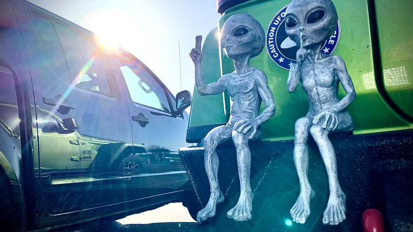 People came from far and wide to the National  Museum of the United States Air Force, Monday, April 8, 2024 to view the eclipse. These two are sitting on the back bumper of a Jeep. MARSHALL GORBY \STAFF