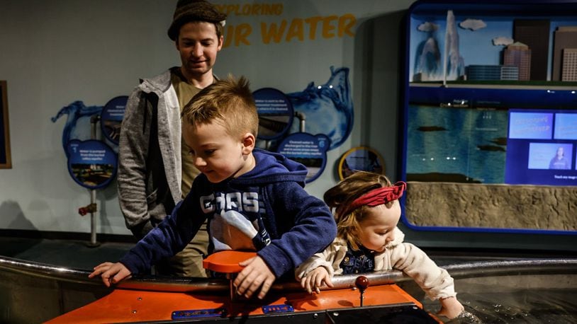 Michael and his siblings Henry and Ariel, from Lewisburg, play with the explore water feature at Boonshoft Museum of Discovery Tuesday January 23, 2024. JIM NOELKER/STAFF