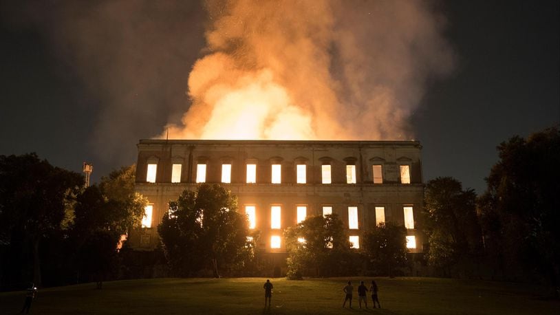 People watch as flames engulf the 200-year-old National Museum of Brazil in Rio de Janeiro on Sunday.