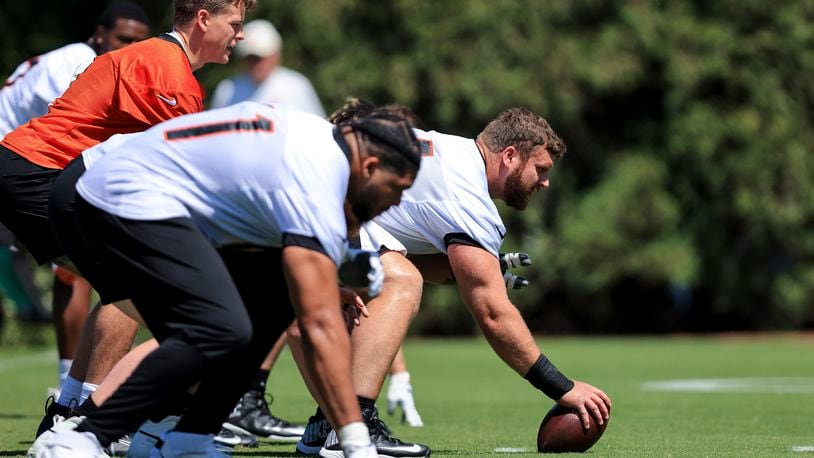 Cincinnati Bengals' Ted Karras, right, sets prior to the play as Joe Burrow gets in position during a drill at NFL football practice in Cincinnati, Tuesday, May 17, 2022. (AP Photo/Aaron Doster)