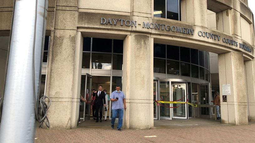 Elijah M. Rashaed, in blue, leaves Dayton Municipal Court on Wednesday. He appeared on behalf of Moonstone Investments LLC, which had a housing case dismissed after issues at a Salem Avenue apartment property were abated. CORNELIUS FROLIK / STAFF