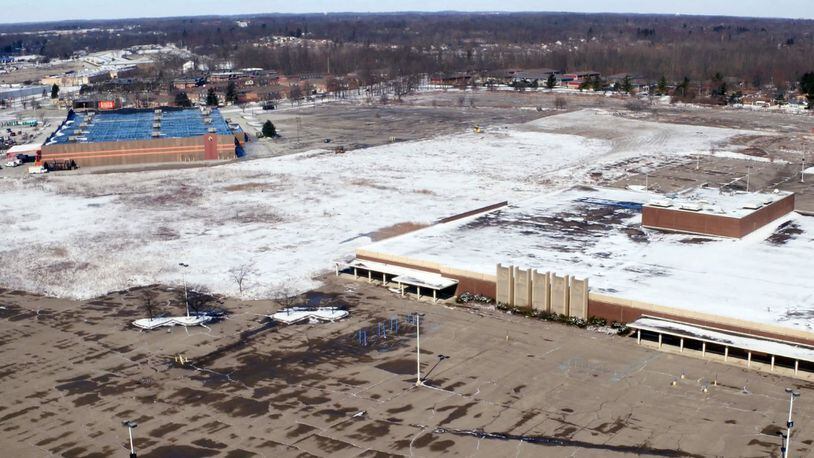 The footprint of the former Salem Mall is covered in snow after clearing and grading of the land was performed in the past week. The old Sears store, right, is all that remains on the site. TY GREENLEES / STAFF