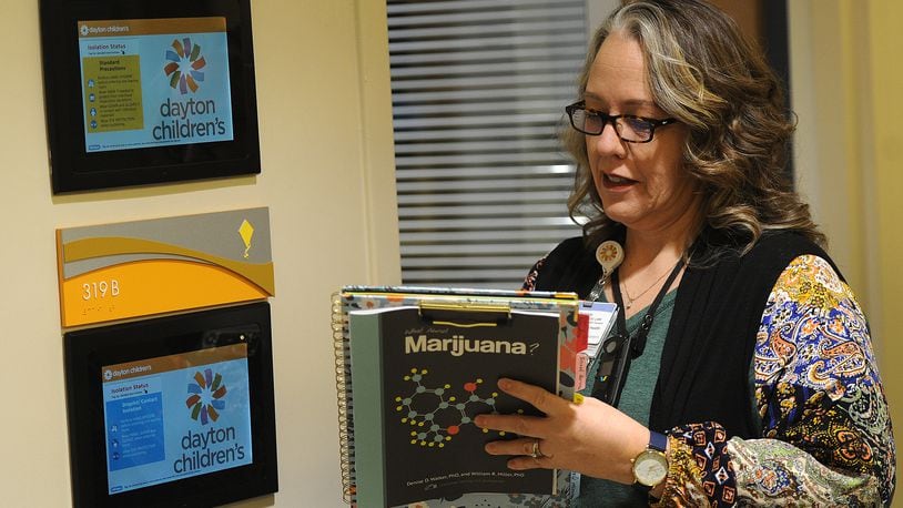 Christine Murray, a licensed therapist, at Dayton Children's Hospital prepares to visit with a patient Thursday, Jan. 11, 2024 to discuss marijuana. MARSHALL GORBY\STAFF