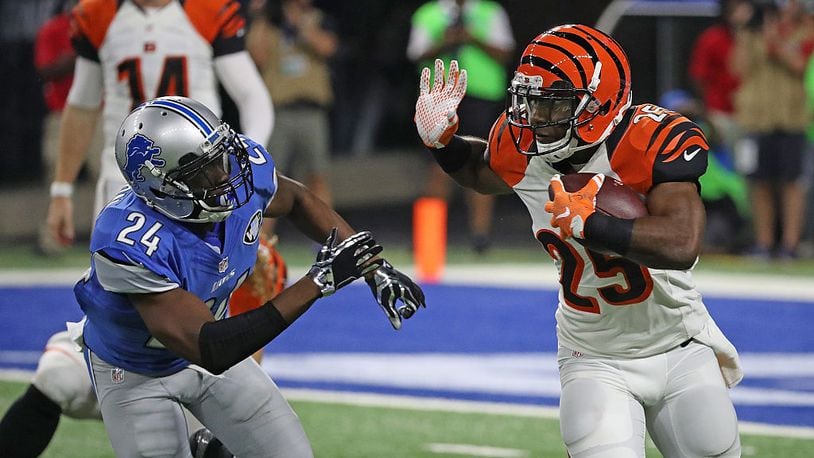 DETROIT, MI - AUGUST 18: Giovani Bernard #25 of the Cincinnati Bengals runs for a short gain as Nevin Lawson #24 of the Detroit Lions attempts to make the stop during the second quarter of the preseason game at Ford Field on August 18, 2016 in Detroit, Michigan. (Photo by Leon Halip/Getty Images)
