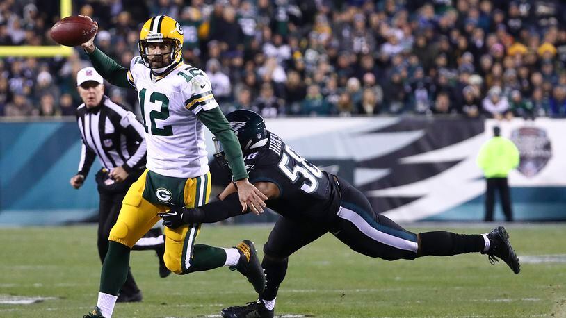 PHILADELPHIA, PA - NOVEMBER 28: Aaron Rodgers #12 of the Green Bay Packers scrambles with the ball against Jordan Hicks #58 of the Philadelphia Eagles in the third quarter at Lincoln Financial Field on November 28, 2016 in Philadelphia, Pennsylvania. (Photo by Al Bello/Getty Images)