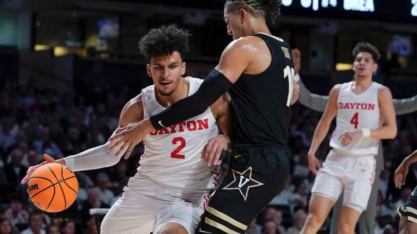 Dayton's Toumani Camara (2) drives against Vanderbilt's Myles Stute (10) in the first half of an NCAA college basketball game in the second round of the NIT Sunday, March 20, 2022, in Nashville, Tenn. (AP Photo/Mark Humphrey)