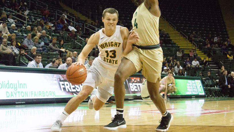 Wright State’s Grant Benzinger looks to drive around Tiffin’s Quentin Jones during Monday’s game at the Nutter Center. Benzinger went over 1,000 career points in the win. ALLISON RODRIGUEZ/CONTRIBUTED