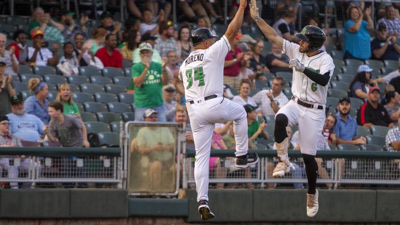 Dragons center fielder Michael Siani celebrates his lead-off homer with manager Jose Moreno in the first inning Tuesday night at Day Air Ballpark. Siani has six homers this season. Jeff Gilbert/CONTRIBUTED