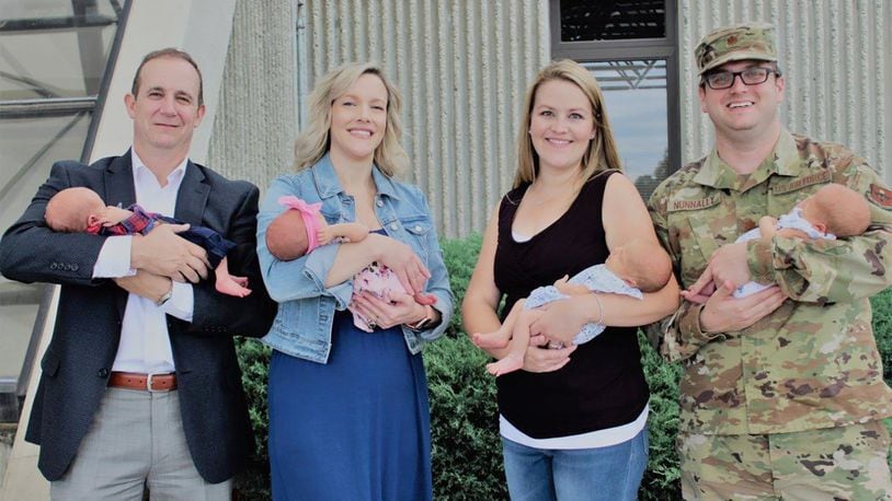 Dale and Crissi Kolomaznik (left) and Katie and Maj. Beau Nunnally (right) reunite at the Wright-Patterson Medical Center with their twins who were delivered at the center in mid August. (Contributed photo)