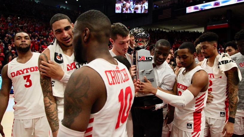 Dayton celebrates with the A-10 championship trophy on Saturday, March 7, 2020, at UD Arena.