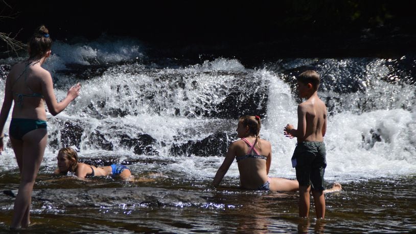 Locals enjoy a swimming break near one of the many waterfalls in North Carolina’s Transylvania County. (Myscha Theriault/TNS)