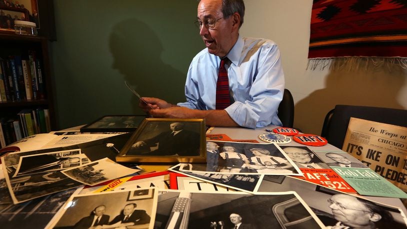 Former Ohio Gov. Bob Taft looks through photographs and memorobilia relating to his grandfather the late Sen. Robert A. Taft who tried three times to become the Republican nominee for president. LISA POWELL / STAFF