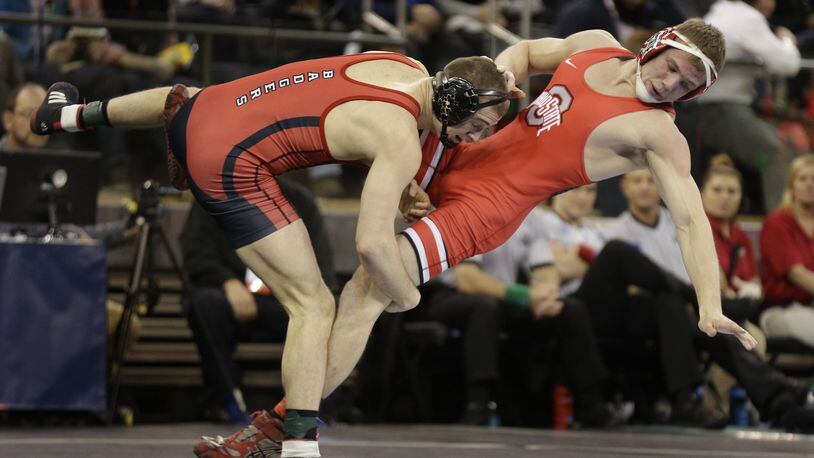 Wisconsin’s Isaac Jordan (left) takes down Ohio State’s Bo Jordan in a 165-pound match during the semifinal of the NCAA Division I wrestling championships in 2016 at New York. The cousins were teammates at Graham High School. (AP Photo/Julie Jacobson)