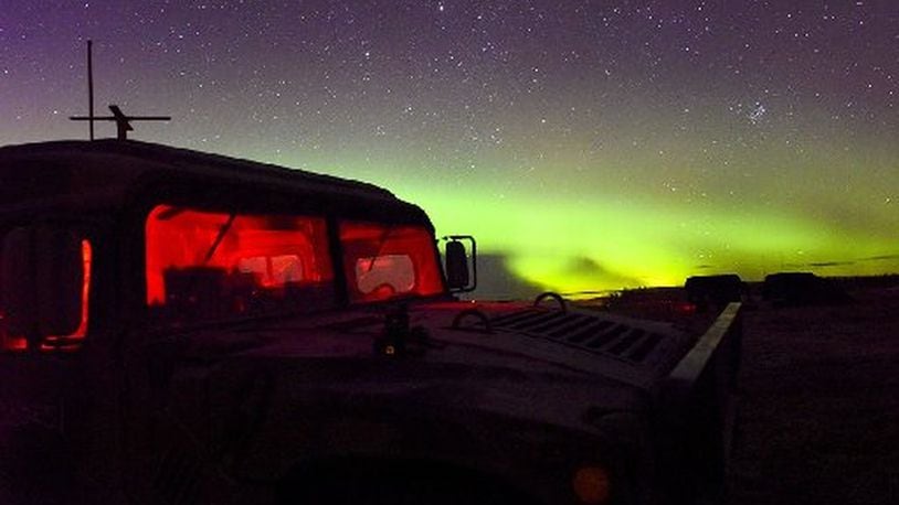 A U.S. Air Force Humvee, assigned to Det. 1, 3rd Air Support Operations Squadron sits under the Aurora Borealis, Oct. 9, 2018, in the Donnelly Training Area, Alaska. (U.S. Air Force photo by Senior Airman Isaac Johnson/CONTRIBUTED)