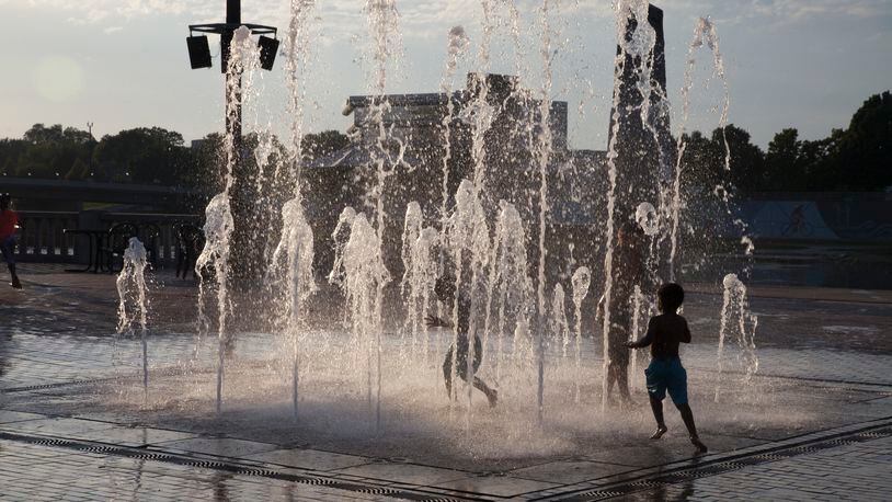 Child playing in interactive fountain at RiverScape MetroPark.
