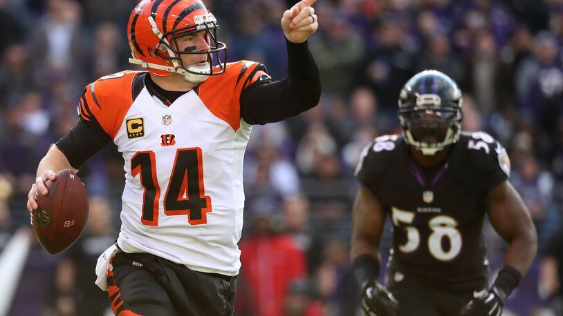 BALTIMORE, MD - NOVEMBER 27: Quarterback Andy Dalton #14 of the Cincinnati Bengals looks to pass while under pressure from outside linebacker Elvis Dumervil #58 of the Baltimore Ravens in the first quarter at M&T Bank Stadium on November 27, 2016 in Baltimore, Maryland. (Photo by Rob Carr/Getty Images)