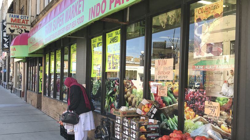 On Devon Ave., on Chicago’s north side, visitors can window shop for beautiful saris and vibrant produce as some 19 blocks of Indian restaurants send whiffs of garlic and curry into the air. (Amelia Rayno/Minneapolis Star Tribune/TNS)