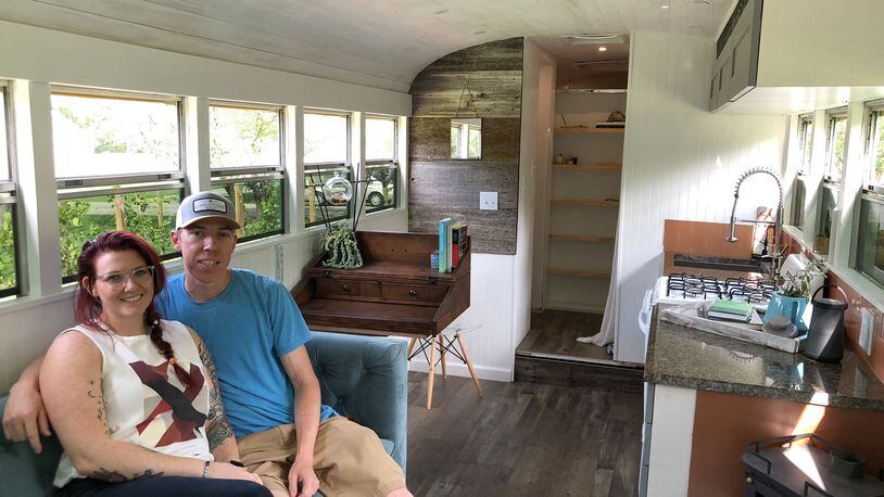 Jordan and Sam Page have converted a 2003 Chevrolet Blue Bird school bus into a tiny house. The two plan to travel the country in their new home, which was built at a cost of less than $20,000. (Matt Riedel/Wichita Eagle/TNS)