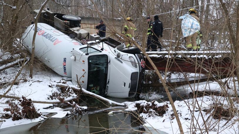 A liquid propane tanker truck slid off a bridge into a creek while it was being towed from private property Monday, Jan. 24, 2022, in the 1000 block of Shrine Road in Springfield Twp. BILL LACKEY/STAFF